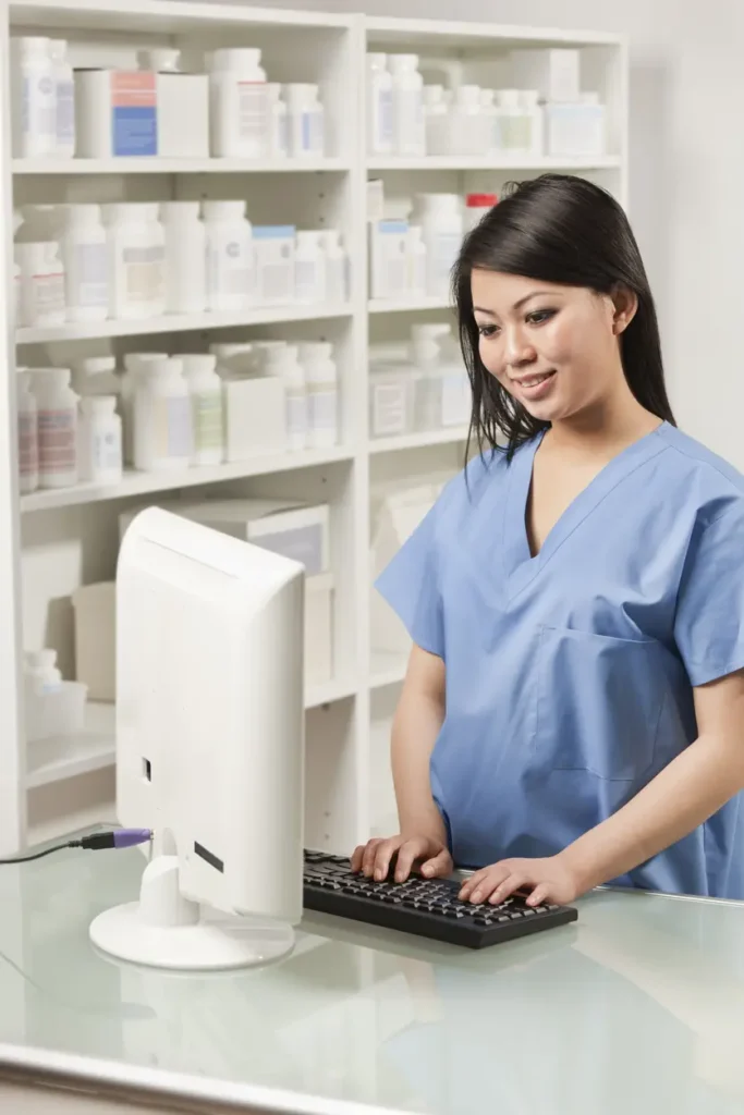 healthcare worker typing info on the computer